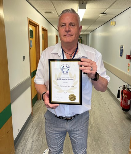 WUTH Health and Safety Manager, Andre Haynes holding the RoSPA Gold Award Certificate 2024