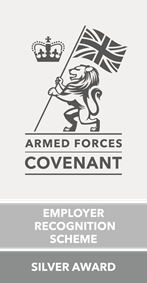 Pale grey logo with drawing of lion holding a Union Jack next to a crown and text in dark grey saying Armed Forces Covenant, Employer Recognition Scheme, Silver Award