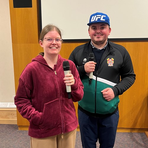 Photo of Lauren and Liam from Autism Together holding microphones