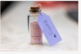 Tiny jar with scroll print of heartbeat